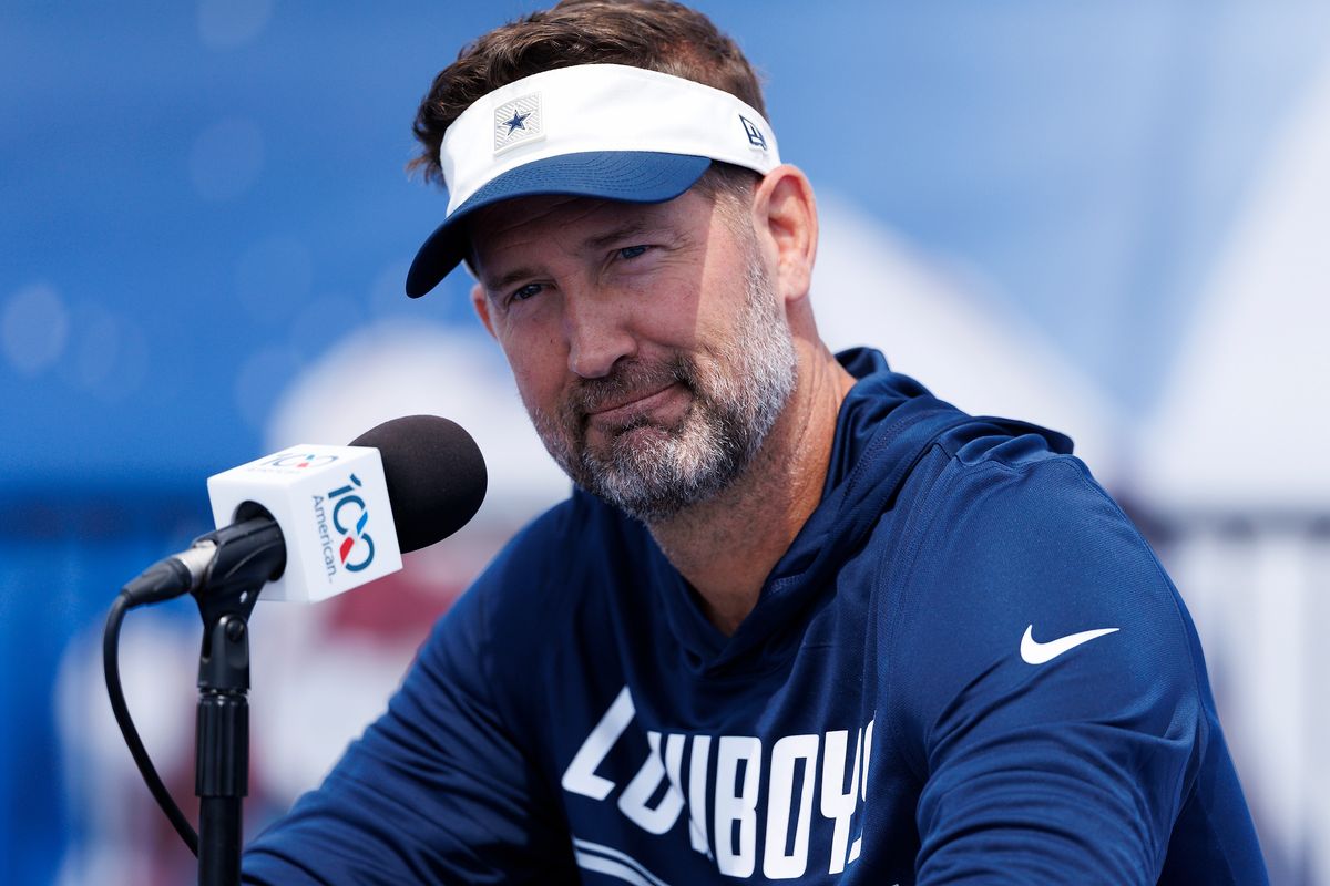 Brian Schottenheimer of the Dallas Cowboys speaks with members of the media during training camp at River Ridge Playing Fields on July 30, 2026 in Oxnard, California. Brian Schottenheimer of the Dallas Cowboys speaks with members of the media during training camp at River Ridge Playing Fields on July 30, 2026 in Oxnard, California.