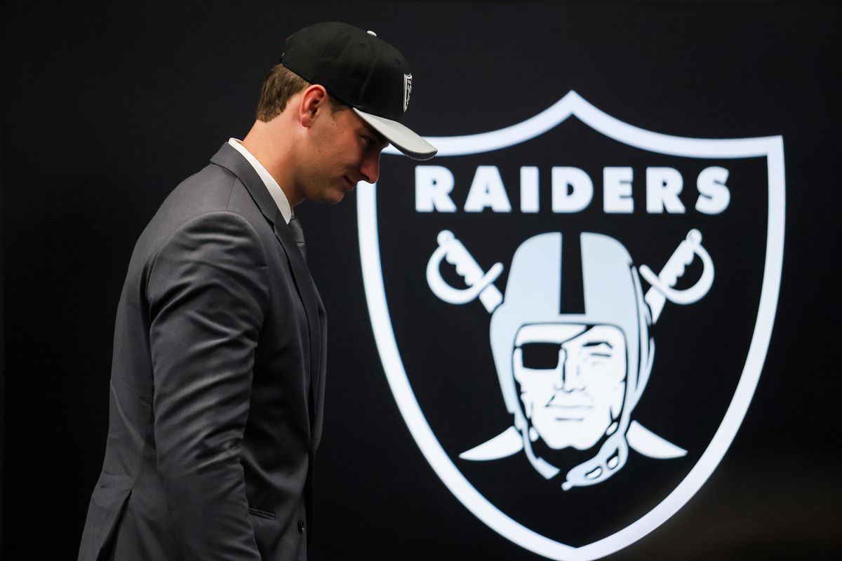 Las Vegas Raiders quarterback Fernando Mendoza walks past the Raiders’ logo after a press conference, Friday April 24, 2026 in Henderson, Nev. Las Vegas Raiders quarterback Fernando Mendoza walks past the Raiders’ logo after a press conference, Friday April 24, 2026 in Henderson, Nev.