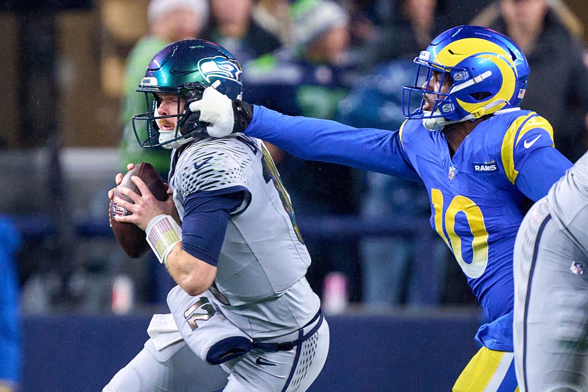 Seattle Seahawks quarterback Sam Darnold (14) battles with Los Angeles Rams linebacker Josaiah Stewart (10) during an NFL football game against the Los Angeles Rams, on Thursday December 18, 2025 in Seattle, Washington. Seattle Seahawks quarterback Sam Darnold (14) battles with Los Angeles Rams linebacker Josaiah Stewart (10) during an NFL football game against the Los Angeles Rams, on Thursday December 18, 2025 in Seattle, Washington.