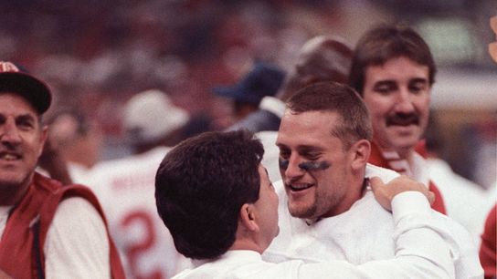 San Francisco 49ers owner Eddie DeBartolo Jr. talks with running back Tom Rathman (44) on the sidelines against the Denver Broncos during Super Bowl XXIV at the Superdome. The 49ers defeated the Broncos 55-10.