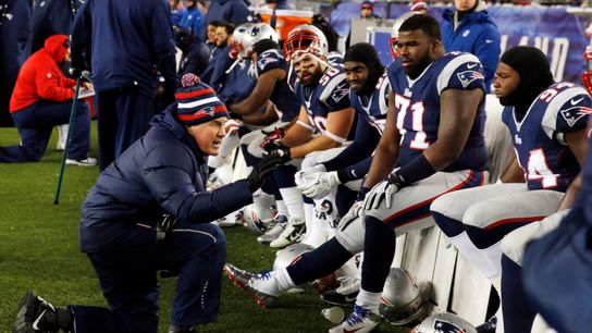 New England Patriots head coach Bill Belichick talks to his players on the sideline as they take on the Miami Dolphins during the first quarter at Gillette Stadium. 