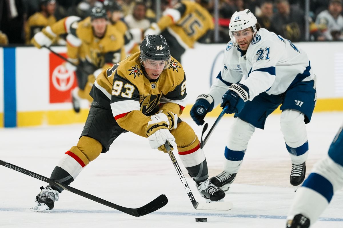 Vegas Golden Knights right wing Mitch Marner (93) controls the puck while attempting to escape Tampa Bay Lightning center Brayden Point (21) during first period of NHL game against Tampa Bay Lightning on Tuesday, Nov. 6, 2025 at T-Mobile Arena in Las Vegas. Vegas Golden Knights right wing Mitch Marner (93) controls the puck while attempting to escape Tampa Bay Lightning center Brayden Point (21) during first period of NHL game against Tampa Bay Lightning on Tuesday, Nov. 6, 2025 at T-Mobile Arena in Las Vegas.