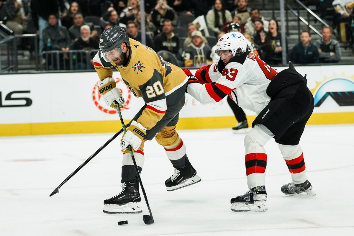 Vegas Golden Knights left wing Brandon Saad prepares to shoot the puck while pushed by Devils defensemen Luke Hughes (43) during second period of NHL game against New Jersey Devils on Wed., Dec. 17, 2025, at T-Mobile Arena in Las Vegas. Vegas Golden Knights left wing Brandon Saad prepares to shoot the puck while pushed by Devils defensemen Luke Hughes (43) during second period of NHL game against New Jersey Devils on Wed., Dec. 17, 2025, at T-Mobile Arena in Las Vegas.