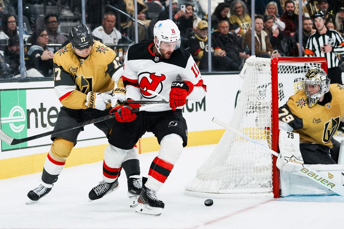 Golden Knights defensemen Ben Hutton (17) tries to block Devils right wing Stefan Noesen (11) from scoring a goal while goalie Carter Hart (79) eyes the puck during third period of NHL game against New Jersey Devils on Wed., Dec. 17, 2025, at T-Mobile Arena in Las Vegas. Golden Knights defensemen Ben Hutton (17) tries to block Devils right wing Stefan Noesen (11) from scoring a goal while goalie Carter Hart (79) eyes the puck during third period of NHL game against New Jersey Devils on Wed., Dec. 17, 2025, at T-Mobile Arena in Las Vegas.