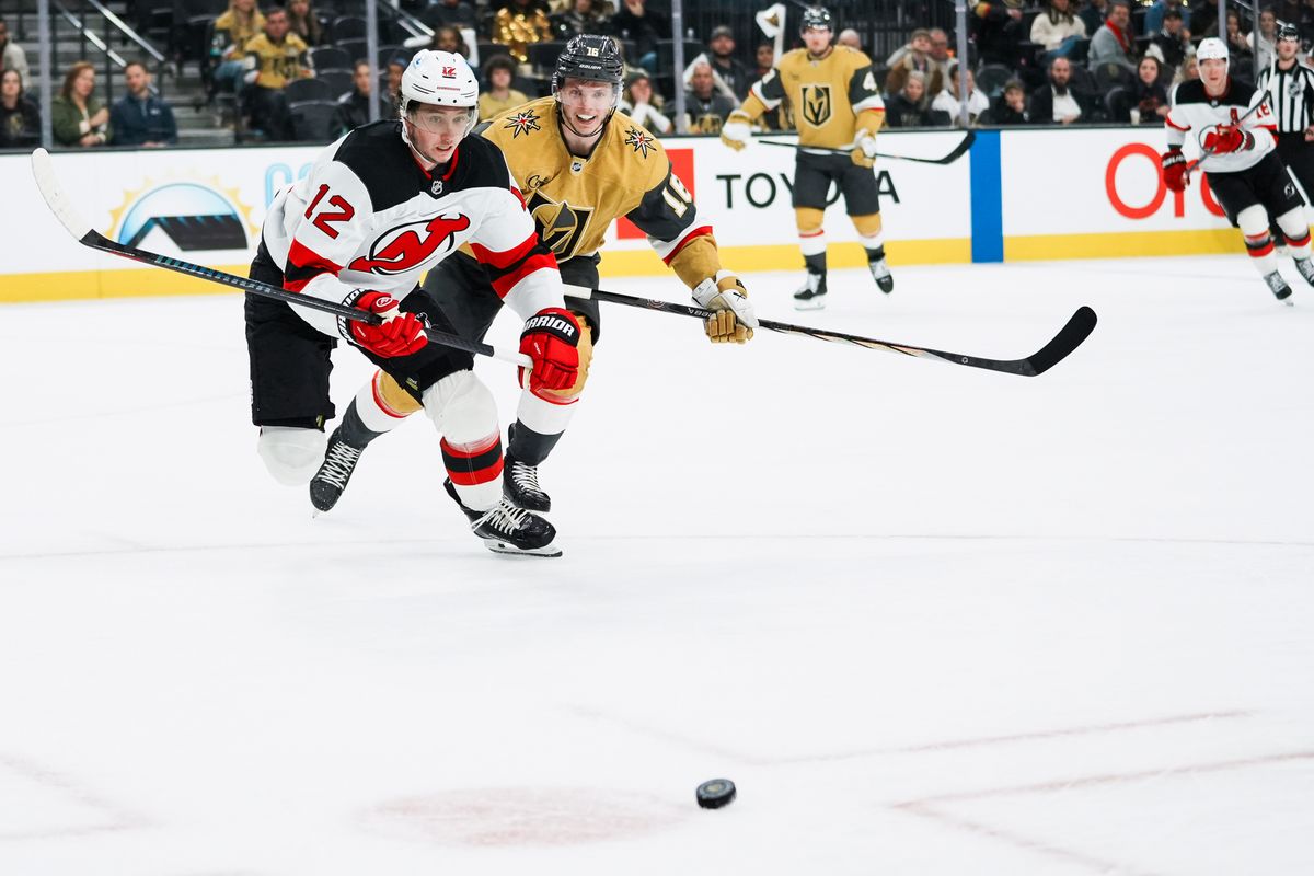 Devils center Cody Glass (12) and Golden Knights right wing Pavel Dorofeyev (16) race towards the puck during third period of NHL game against New Jersey Devils on Wed., Dec. 17, 2025, at T-Mobile Arena in Las Vegas. Devils center Cody Glass (12) and Golden Knights right wing Pavel Dorofeyev (16) race towards the puck during third period of NHL game against New Jersey Devils on Wed., Dec. 17, 2025, at T-Mobile Arena in Las Vegas.