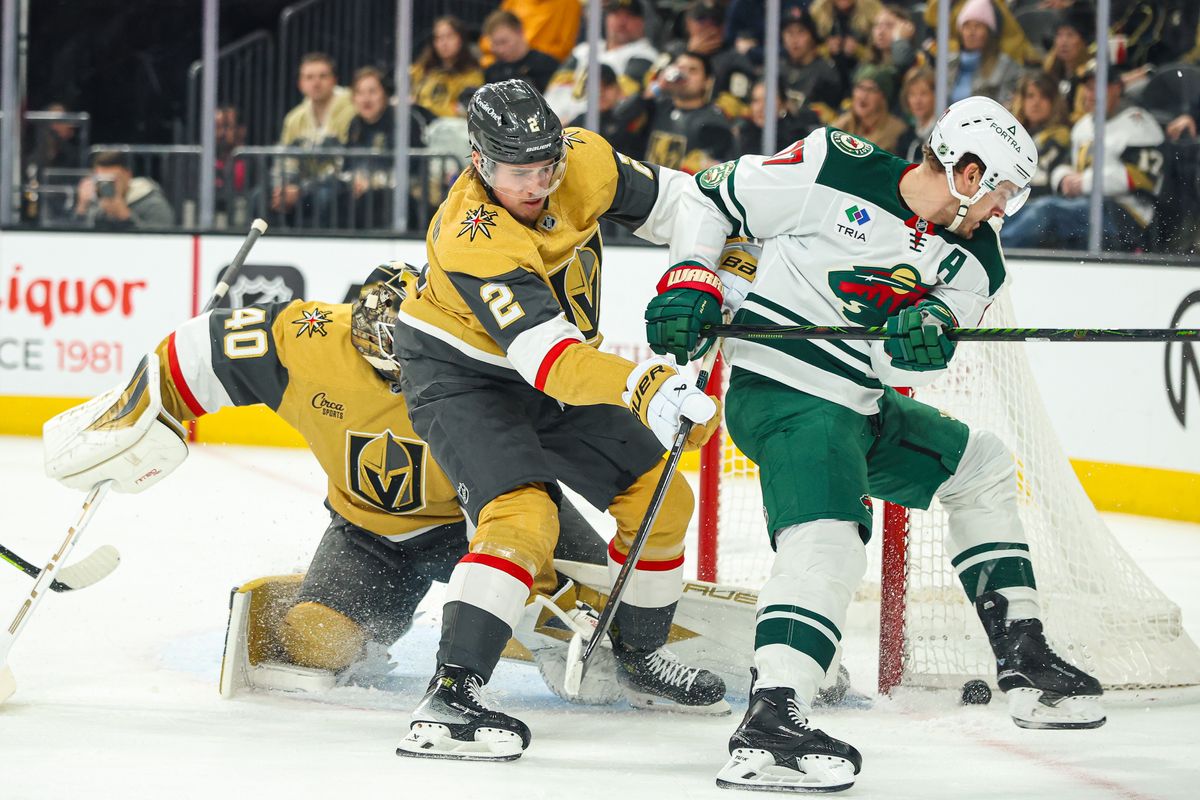 Vegas Golden Knights D Zach Whitecloud (2) pushes Minnesota Wild F Marcus Foligno (17) off the puck during an NHL game on Monday December 29, 2025, in Las Vegas, Nevada. Vegas Golden Knights D Zach Whitecloud (2) pushes Minnesota Wild F Marcus Foligno (17) off the puck during an NHL game on Monday December 29, 2025, in Las Vegas, Nevada.