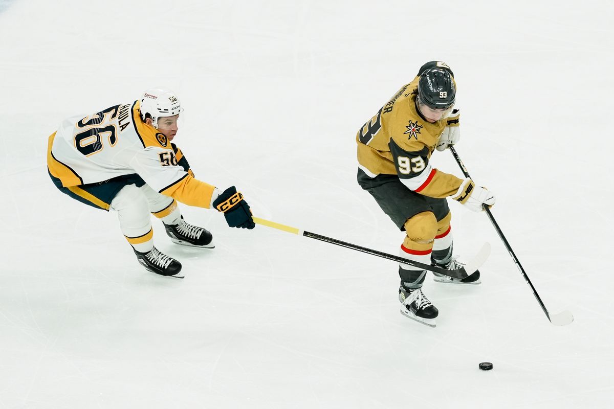 Nashville Predators left wing Erik Haula (58) reached to take the puck from Golden Knights right wing Mitch Marner (93) during first period of NHL game against Vegas Golden Knights on Saturday Jan. 17, 2026 at T-Mobile Arena in Las Vegas. Nashville Predators left wing Erik Haula (58) reached to take the puck from Golden Knights right wing Mitch Marner (93) during first period of NHL game against Vegas Golden Knights on Saturday Jan. 17, 2026 at T-Mobile Arena in Las Vegas.