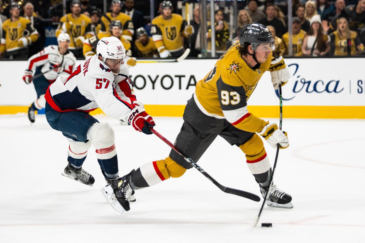 Vegas Golden Knights right-wing Mitch Marner (93) shoots the puck as Washington Capitals defenseman Trevor van Riemsdyk (57) attempts to poke the puck during a NHL game between the Vegas Golden Knights and the Washington Capitals, Saturday March 28, 2026 in Las Vegas, Nev. Vegas Golden Knights right-wing Mitch Marner (93) shoots the puck as Washington Capitals defenseman Trevor van Riemsdyk (57) attempts to poke the puck during a NHL game between the Vegas Golden Knights and the Washington Capitals, Saturday March 28, 2026 in Las Vegas, Nev.