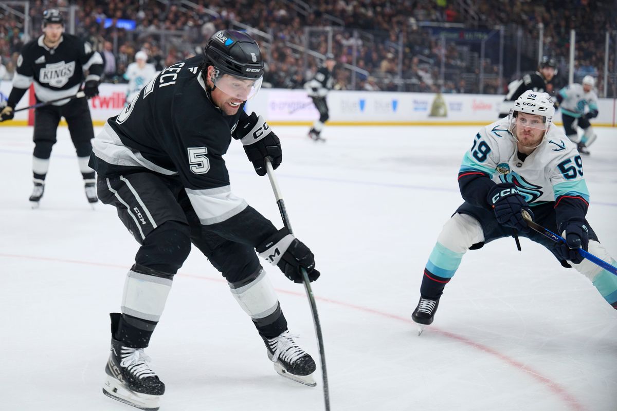 Los Angeles Kings defenseman Cody Ceci (5) clears the puck against the Kraken at the crypto.com Arena on December 23,2025 in Los Angeles, California. Los Angeles Kings defenseman Cody Ceci (5) clears the puck against the Kraken at the crypto.com Arena on December 23,2025 in Los Angeles, California.