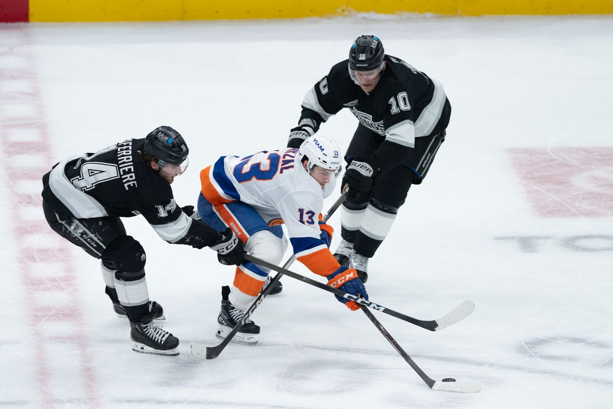 New York Islanders center Mathew Barzal (13) pushes the puck through two defenders during an NHL game between the New York Islanders and the Los Angeles Kings on Thursday, March 5, 2026 at Crypto.com Arena in Los Angeles Calif New York Islanders center Mathew Barzal (13) pushes the puck through two defenders during an NHL game between the New York Islanders and the Los Angeles Kings on Thursday, March 5, 2026 at Crypto.com Arena in Los Angeles Calif