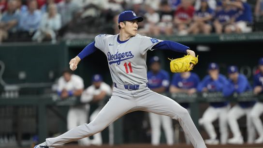 Los Angeles Dodgers starting pitcher Roki Sasaki (11) delivers a pitch to the Texas Rangers during the first inning at Globe Life Field. 