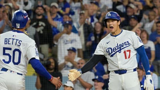 Los Angeles Dodgers shortstop Mookie Betts (50) and designated hitter Shohei Ohtani (17) celebrate after scoring against the Cincinnati Reds in the sixth inning during game two of the Wildcard round f... Los Angeles Dodgers shortstop Mookie Betts (50) and designated hitter Shohei Ohtani (17) celebrate after scoring against the Cincinnati Reds in the sixth inning during game two of the Wildcard round f...