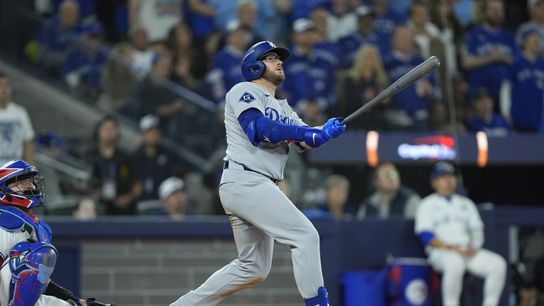 Los Angeles Dodgers third baseman Max Muncy (13) hits a home run against the Toronto Blue Jays in the eighth inning during game seven of the 2025 MLB World Series at Rogers Centre. 