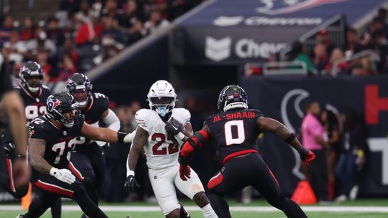Dec 14, 2025; Houston, Texas, USA; Arizona Cardinals running back Michael Carter (22) runs for a gain past Houston Texans linebacker Azeez al-Shaair (0) during the third quarter at NRG Stadium. Dec 14, 2025; Houston, Texas, USA; Arizona Cardinals running back Michael Carter (22) runs for a gain past Houston Texans linebacker Azeez al-Shaair (0) during the third quarter at NRG Stadium.