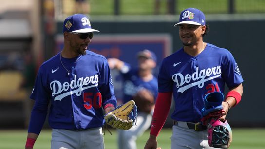 Los Angeles Dodgers shortstop Mookie Betts (50) and Santiago Espinal warm up before a game against the Colorado Rockies at Salt River Fields at Talking Stick. Los Angeles Dodgers shortstop Mookie Betts (50) and Santiago Espinal warm up before a game against the Colorado Rockies at Salt River Fields at Talking Stick.