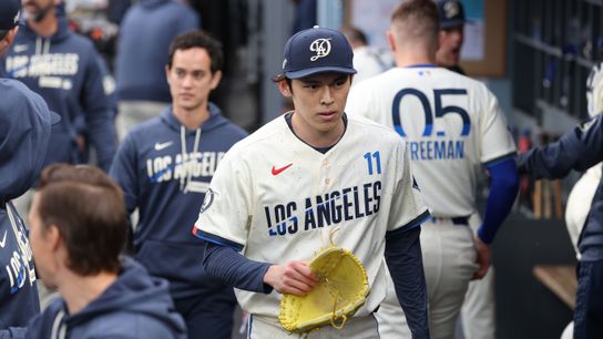 Los Angeles Dodgers starting pitcher Roki Sasaki (11) walks in the dugout after the first inning against the Chicago Cubs at Dodger Stadium. Los Angeles Dodgers starting pitcher Roki Sasaki (11) walks in the dugout after the first inning against the Chicago Cubs at Dodger Stadium.