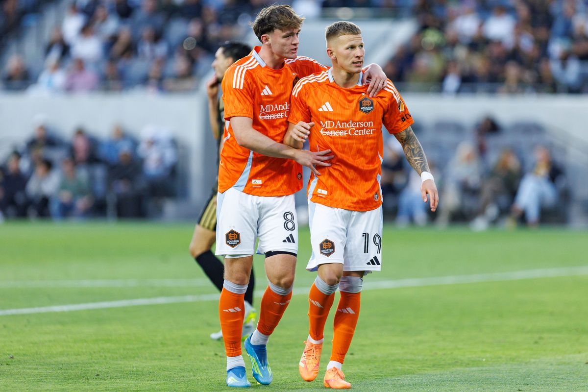Mateusz Bogusz #19 of Houston Dynamo FC celebrates with Jack McGlynn #8 after scoring a goal during an MLS match against LAFC on May 10, 2026 at BMO Stadium in Los Angeles, California. Mateusz Bogusz #19 of Houston Dynamo FC celebrates with Jack McGlynn #8 after scoring a goal during an MLS match against LAFC on May 10, 2026 at BMO Stadium in Los Angeles, California.