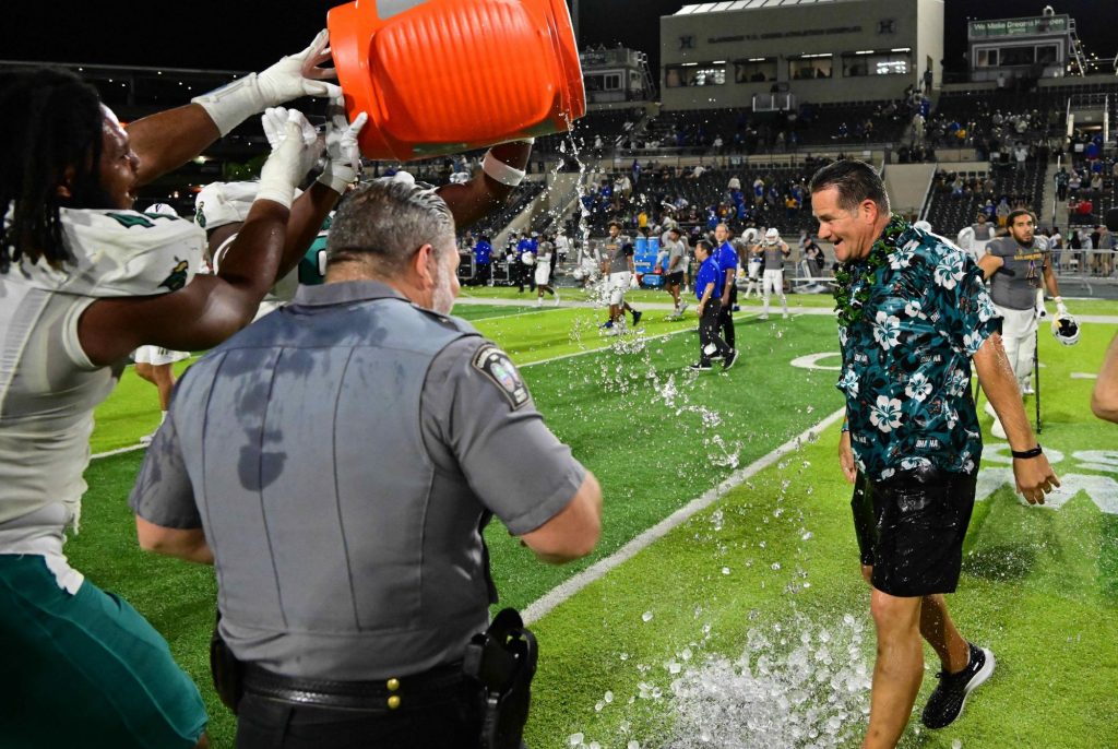 Dec 23, 2023; Honolulu, HI, USA; Coastal Carolina Chanticleers defensive lineman Will Whitson (44) dumps water on head coach Tim Beck upon defeating the San Jose State Spartans to win the Easypost Hawaii Bowl between the Coastal Carolina Chanticleers and the San Jose State Spartans played on December 23, 2023 at Clarence T.C. Ching Athletics Complex. Mandatory Credit: Steven Erler-USA TODAY Sports
