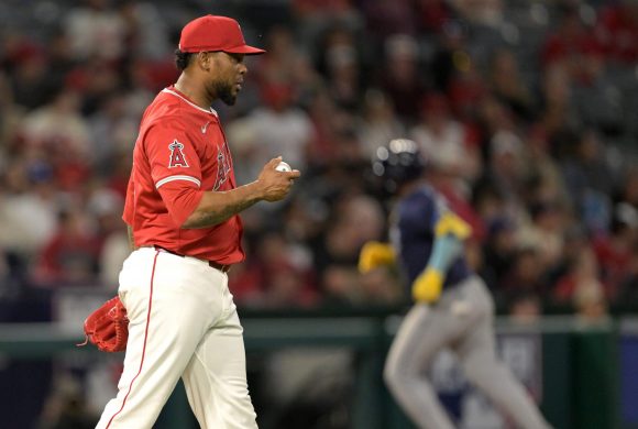 Apr 9, 2024; Anaheim, California, USA; Los Angeles Angels pitcher Jose Cisnero (67) checks the ball after giving up a solo home run to Tampa Bay Rays third base Isaac Paredes (17) in the seventh inning at Angel Stadium.